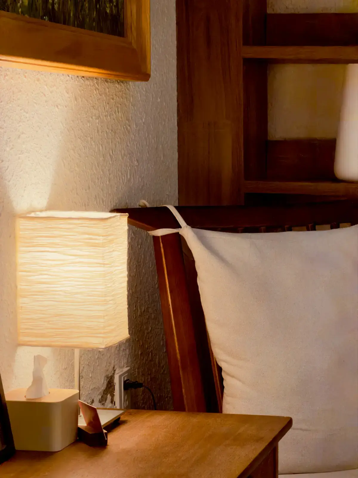 The Ro oak nightstand with a glowing bedside lamp