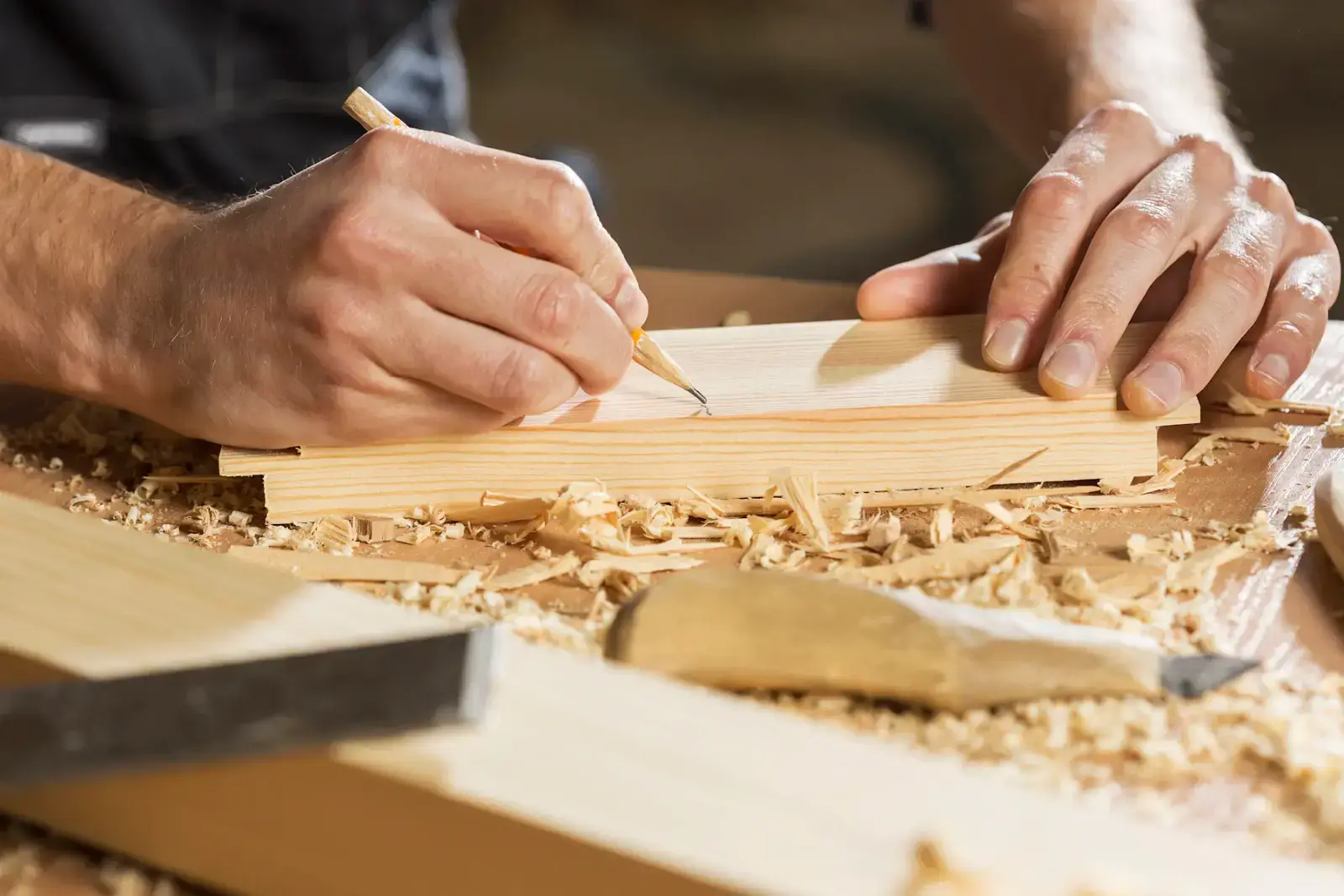 A pencil line being marked on a planed oak board