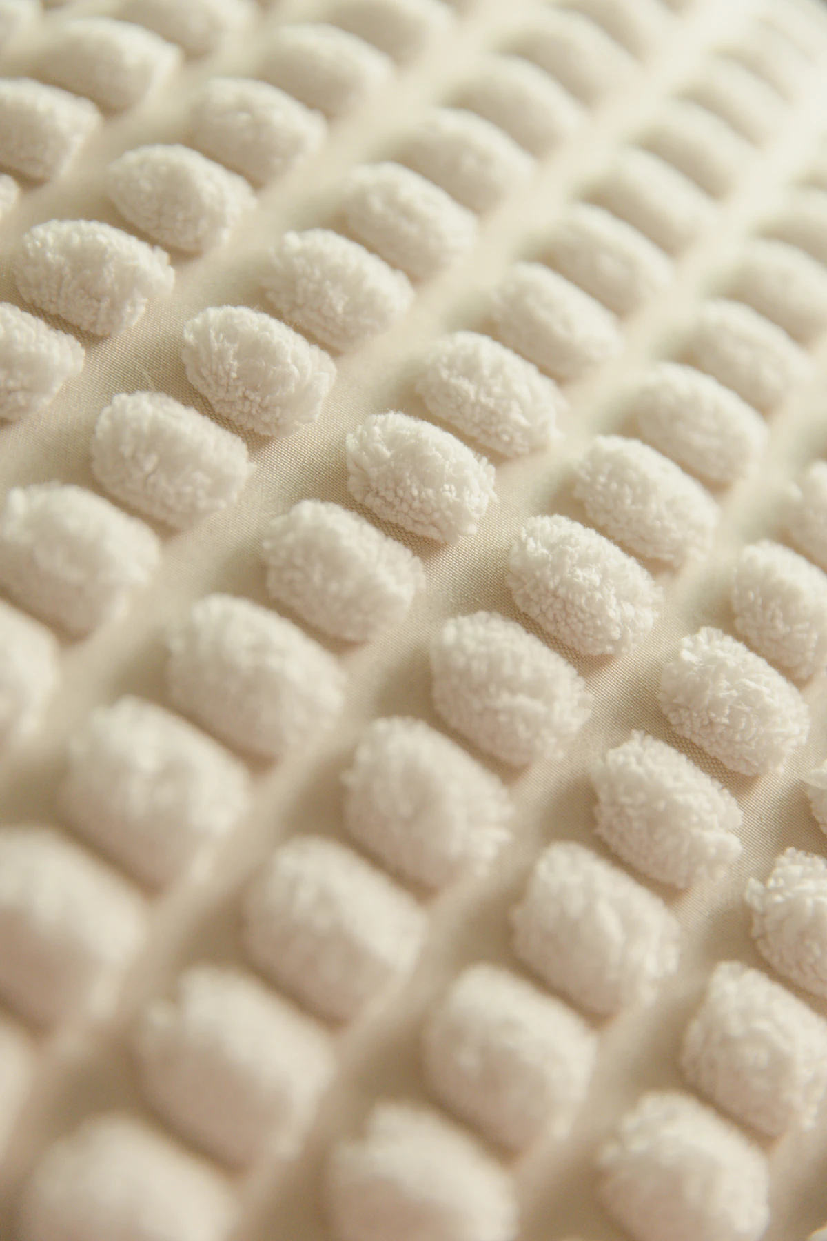 Close-up of soft, cream-coloured textured foam