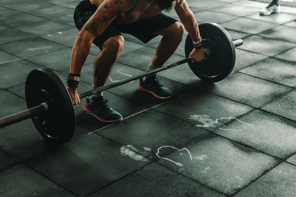 A lifter crouched over a loaded barbell