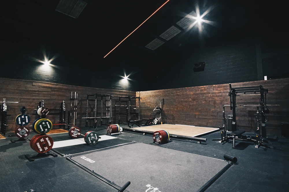 A wide view of the gym floor with racks and platforms